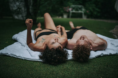 Young woman lying on grass