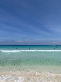 Scenic view of beach against blue sky