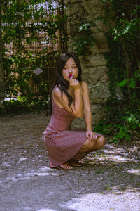 Portrait of smiling young woman sitting outdoors