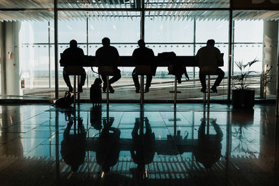 Silhouette people waiting at airport