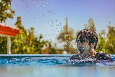 Side view of woman swimming in pool