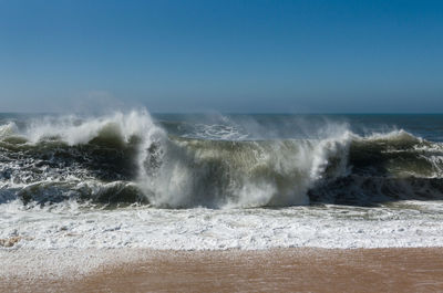 Scenic view of sea against clear blue sky
