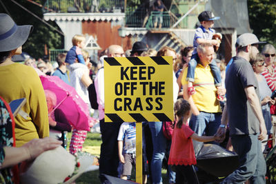 Text on placard amidst crowd