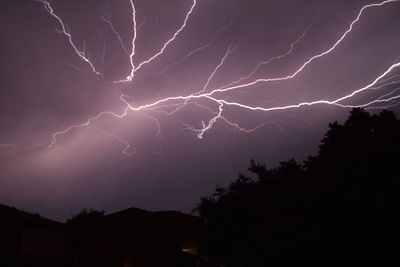 Low angle view of lightning against sky at night