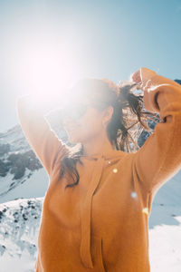 A stylish woman smiles in the winter sun