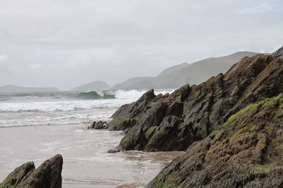 Scenic view of sea and mountains against sky