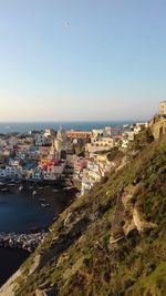High angle view of townscape by sea against clear sky