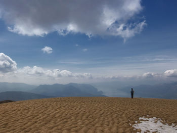 Scenic view of beach against cloudy sky