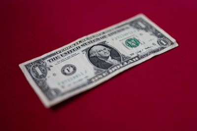 Close-up of paper currency on red background