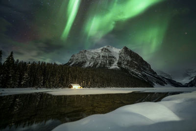 Scenic view of snowcapped mountains against sky at night