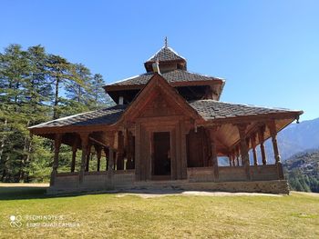 Temple on field against clear sky