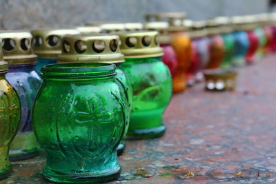Close-up of multi colored jars on table
