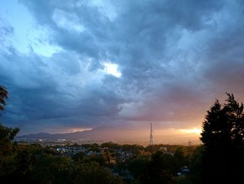 Cityscape against cloudy sky