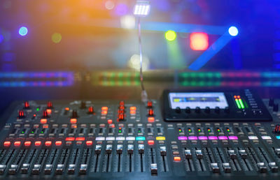 Close-up of illuminated lighting equipment on display at night