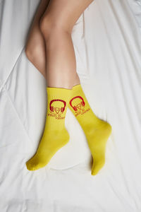 Low section of woman on bed