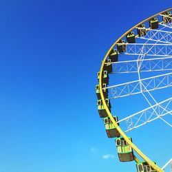 Low angle view of ferris wheel against sky