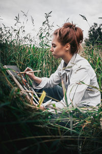 Young woman lying on field