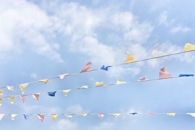 Low angle view of bunting against cloudy sky