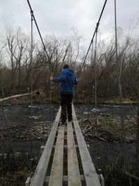 Rear view of man standing on bridge, kamchatka 