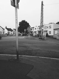 Street and buildings against clear sky