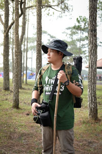 Young man standing in forest