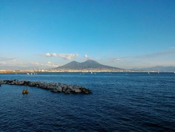 Scenic view of sea against blue sky