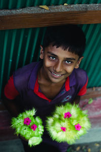 Portrait of smiling boy standing outdoors