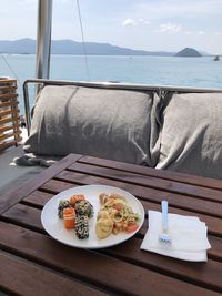 High angle view of breakfast served on table by sea