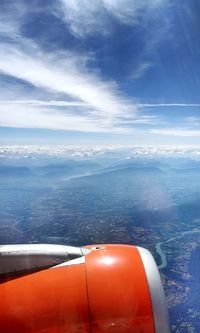 Airplane flying over sea against sky