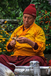 Portrait of senior man sitting on rock