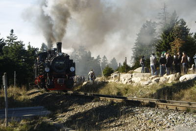 Panoramic view of people on train against sky