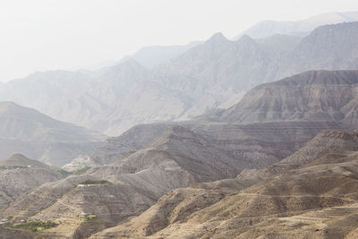 Misty mountain hills landscape. layers of rocky mountains and hills in haze, sepia, gradient. 