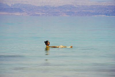 Young woman sitting in lake