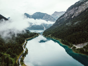 Scenic view of lake and mountains against sky