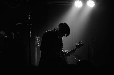 Man playing guitar at music concert