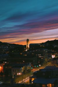 High angle view of illuminated city against sky at sunset