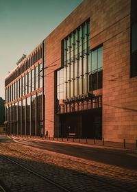 Exterior of railroad station building during sunset