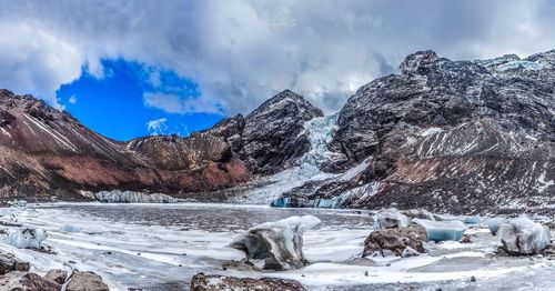 Scenic view of lake and snowcapped mountains against sky