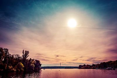 Scenic view of river against sky at sunset