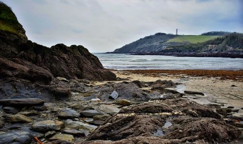 Rocks on beach against sky