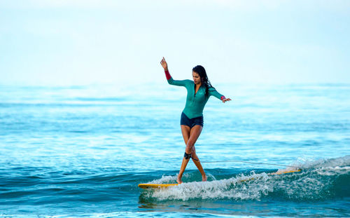 Woman jumping on beach