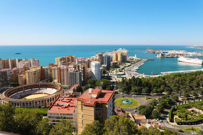 High angle view of buildings and sea against clear sky