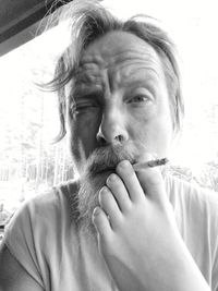 Portrait of man smoking cigarette