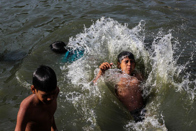 High angle view of shirtless boy in water