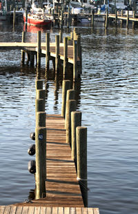 Jetty leading to wooden posts in river