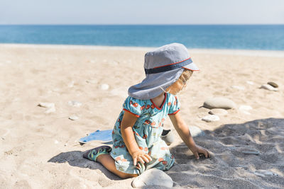 Full length of child on beach against sky