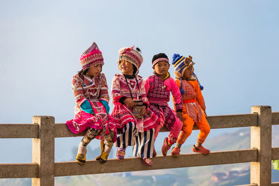 Rear view of children against sky