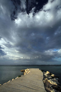 Scenic view of sea against storm clouds