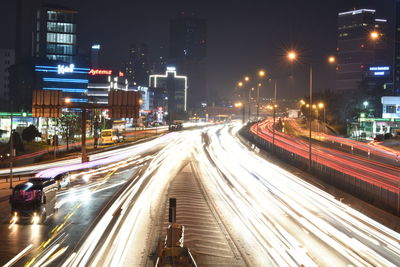 Light trails on road in city at night