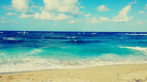 Scenic view of sea against blue sky